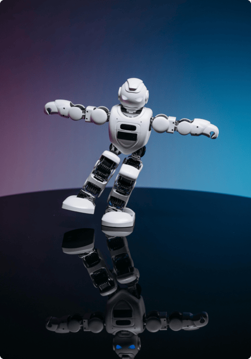 A white humanoid robot with glowing blue eyes balancing dynamically on one leg on a reflective surface, set against a gradient blue and purple background.